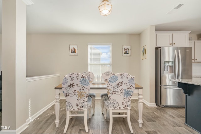 dining area with light hardwood / wood-style flooring