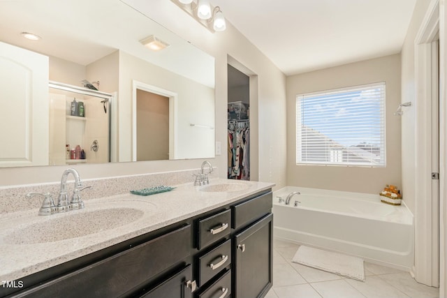 bathroom featuring tile patterned flooring, vanity, and separate shower and tub