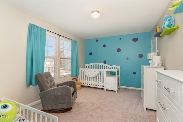 bedroom with a crib and light colored carpet