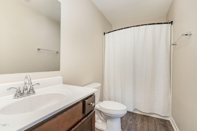 bathroom featuring hardwood / wood-style flooring, vanity, toilet, and a shower with shower curtain