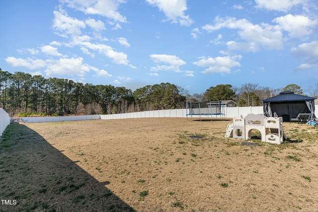 view of yard featuring a gazebo and a trampoline