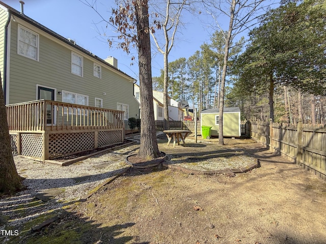 view of yard with a deck and a shed