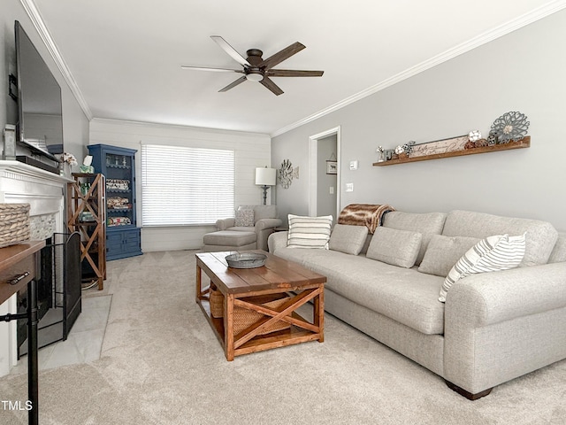 carpeted living room with ceiling fan, ornamental molding, and a fireplace