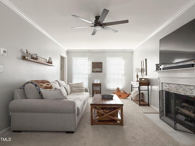 carpeted living room featuring ornamental molding, ceiling fan, and a fireplace