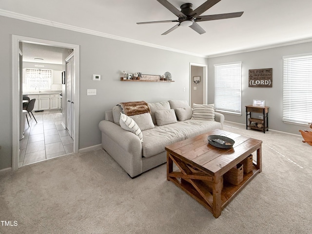 living room with sink, crown molding, light colored carpet, and ceiling fan