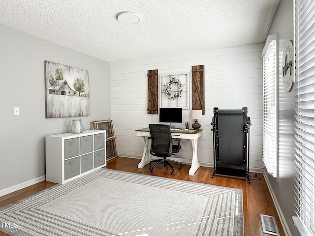 office featuring hardwood / wood-style flooring and a textured ceiling