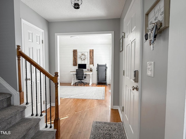 entryway featuring wood-type flooring and a textured ceiling