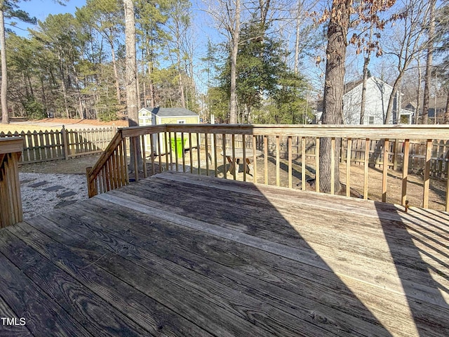 wooden deck featuring a storage unit