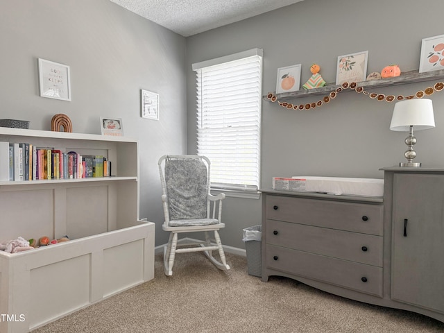 sitting room featuring light colored carpet and a textured ceiling