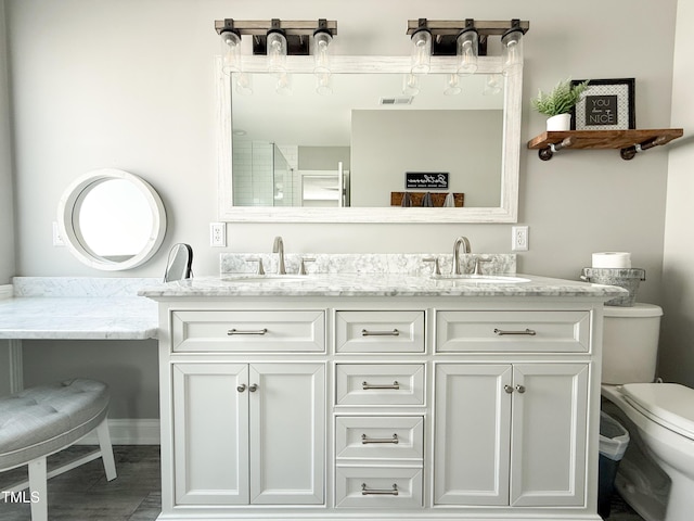 bathroom with vanity and toilet