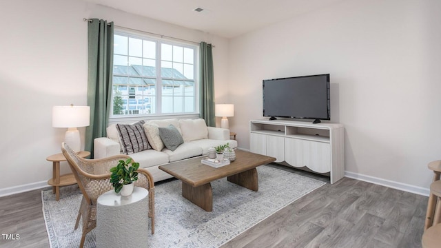 165 Holton St, Smithfield, NC 27577 - living room featuring light wood finished floors, baseboards, and visible vents