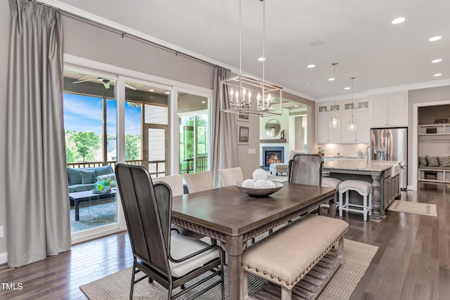 dining space with crown molding, dark wood-type flooring, and a notable chandelier