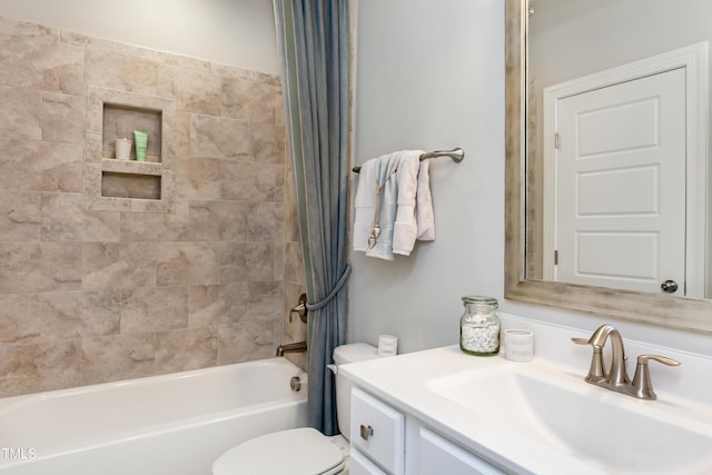 full bathroom featuring shower / tub combo with curtain, vanity, and toilet