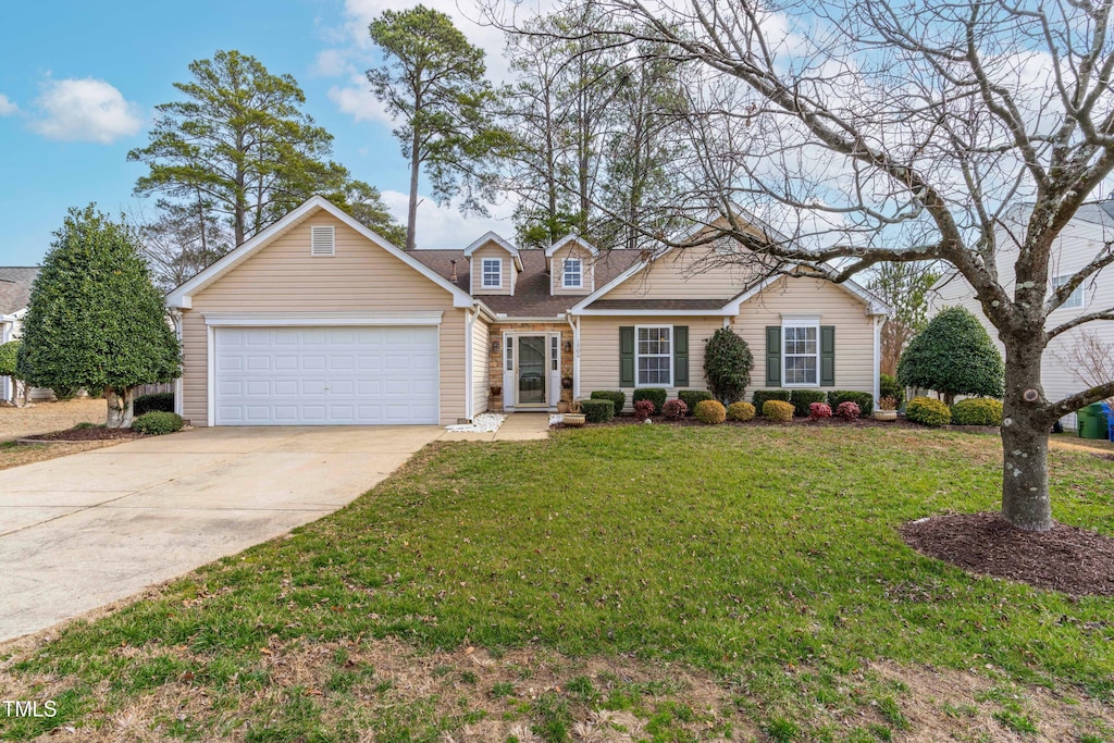 view of front of property with a garage and a front yard