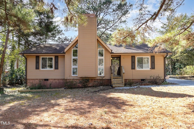 view of front of home with crawl space and a chimney