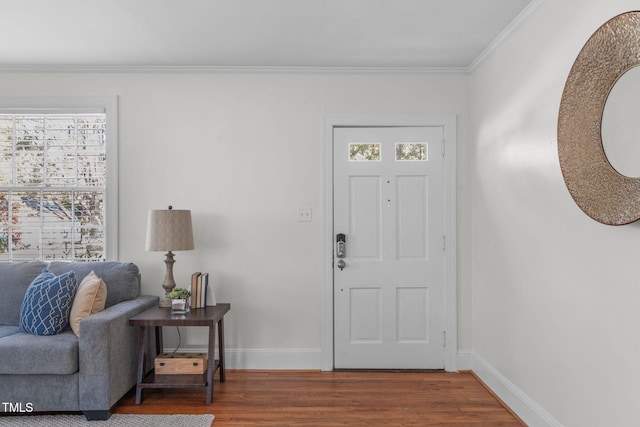 foyer entrance with crown molding and dark hardwood / wood-style flooring