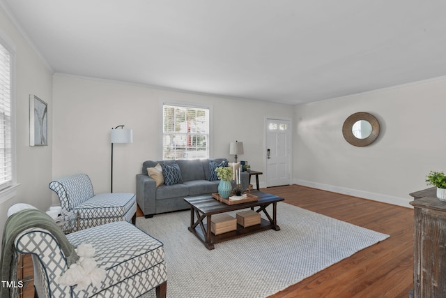 living room with crown molding and hardwood / wood-style floors