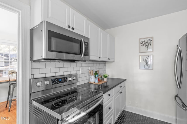 kitchen featuring white cabinetry, tasteful backsplash, and appliances with stainless steel finishes