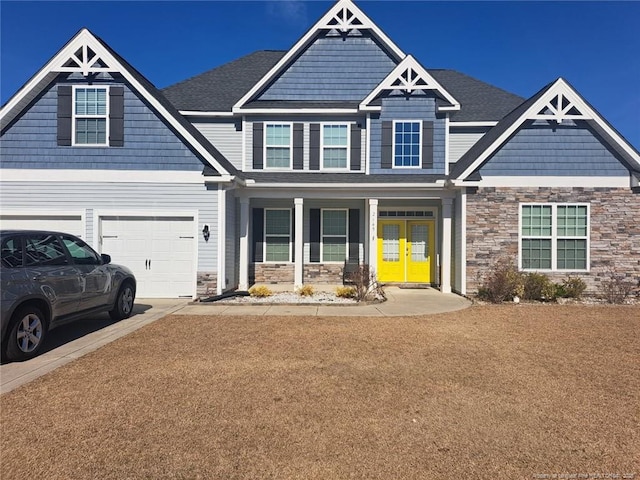 craftsman inspired home featuring a garage and a porch