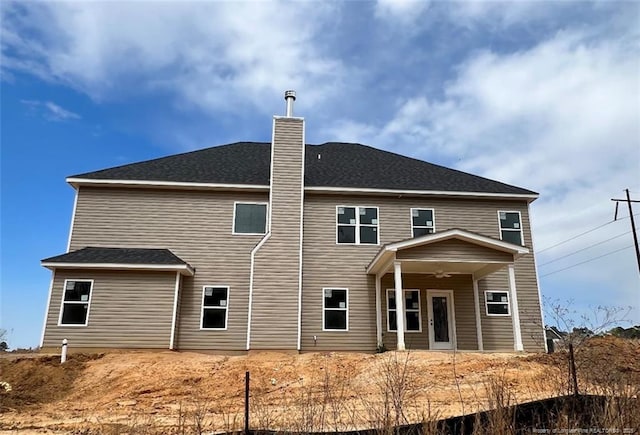 rear view of property with ceiling fan