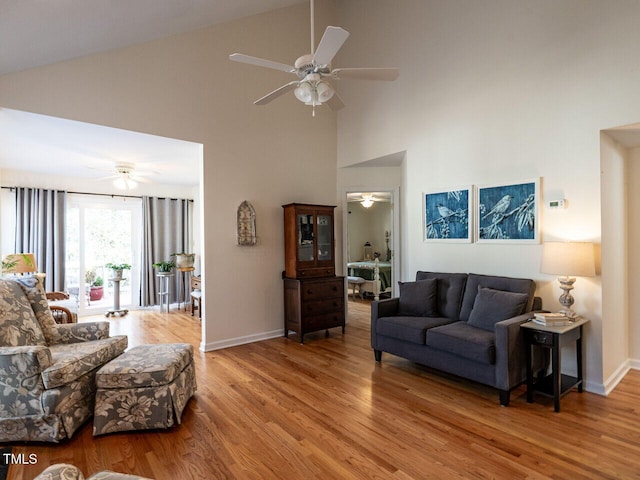 living room featuring high vaulted ceiling, hardwood / wood-style floors, and ceiling fan