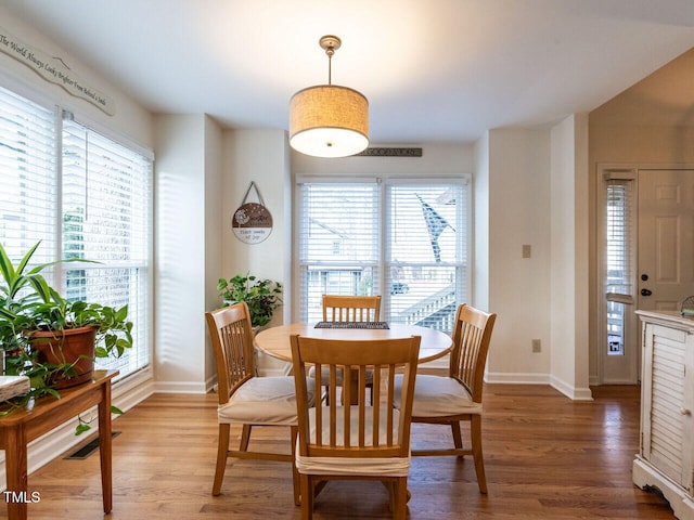 dining area with plenty of natural light and wood-type flooring