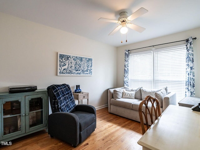 living room featuring ceiling fan and light wood-type flooring