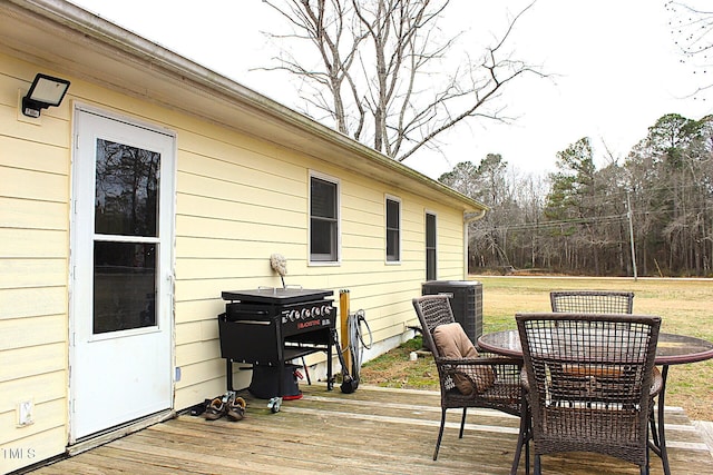 wooden deck featuring cooling unit