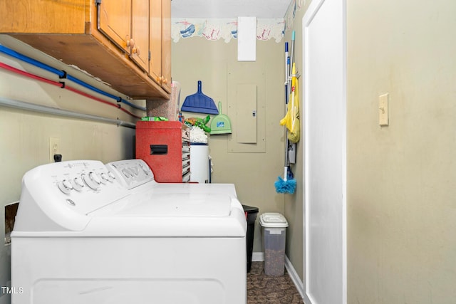 laundry area featuring independent washer and dryer, cabinet space, and baseboards