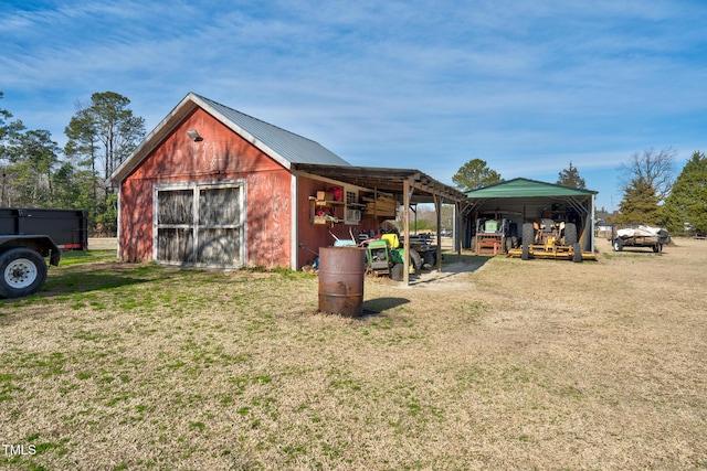 view of pole building with a carport, driveway, and a lawn