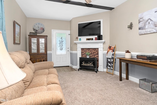 carpeted living area featuring baseboards