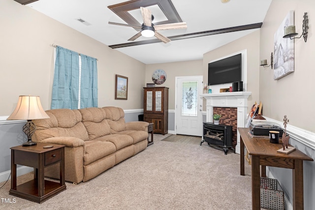 living room featuring carpet floors, ceiling fan, visible vents, and baseboards