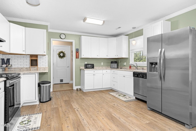 kitchen featuring white cabinetry and appliances with stainless steel finishes