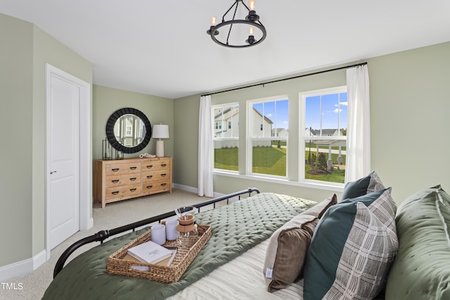 bedroom with carpet flooring and a notable chandelier