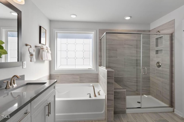 bathroom featuring vanity and shower with separate bathtub