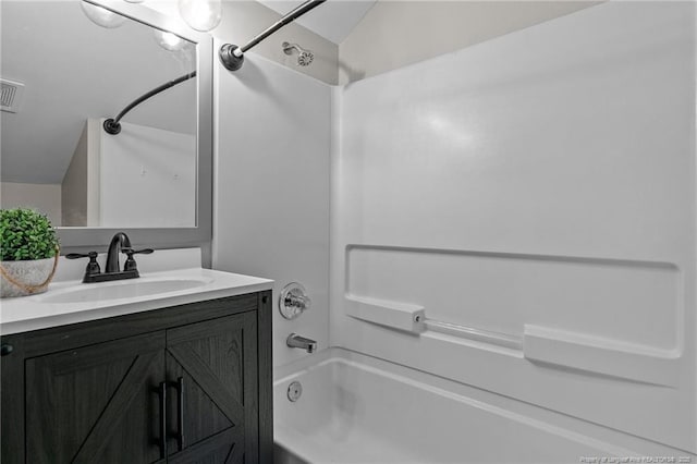 bathroom featuring  shower combination and vanity