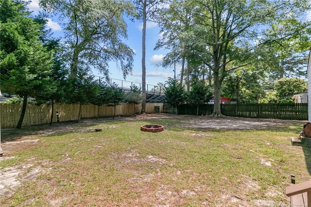 view of yard with a fire pit