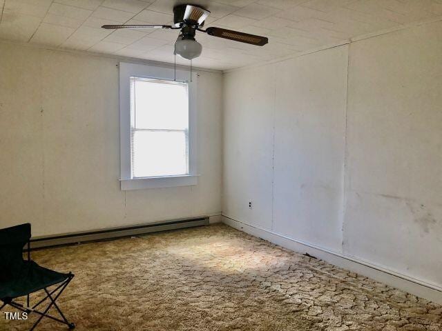 spare room with ceiling fan and baseboard heating