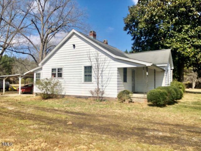 view of side of home featuring a lawn