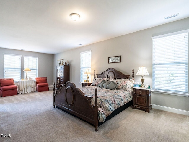 bedroom featuring light colored carpet