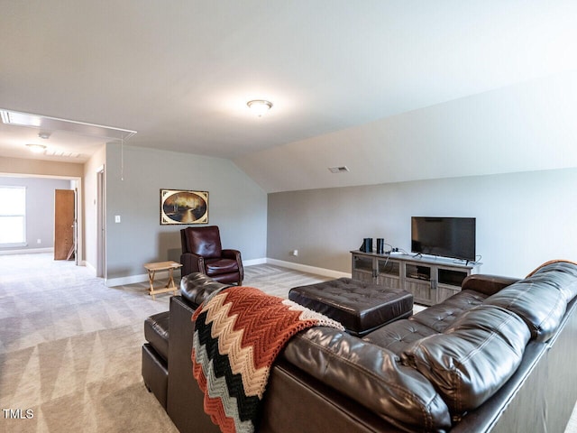 carpeted living room with vaulted ceiling