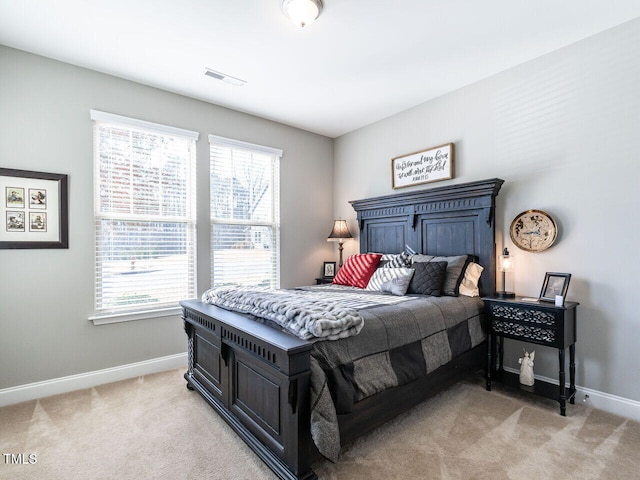 carpeted bedroom featuring multiple windows