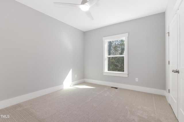 spare room with light carpet and ceiling fan