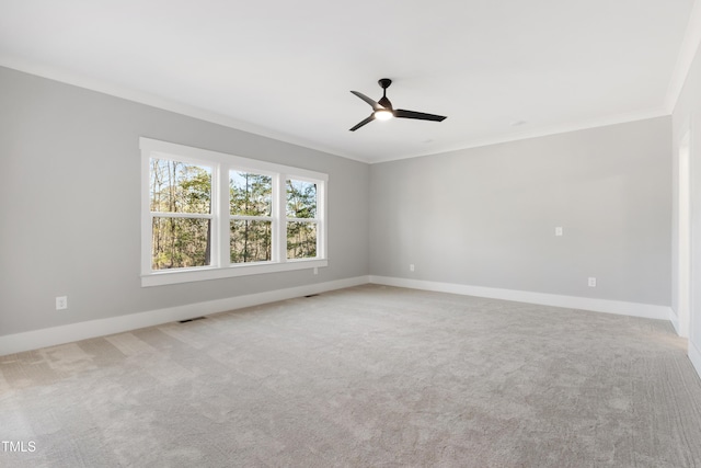 unfurnished room featuring crown molding, light colored carpet, and ceiling fan