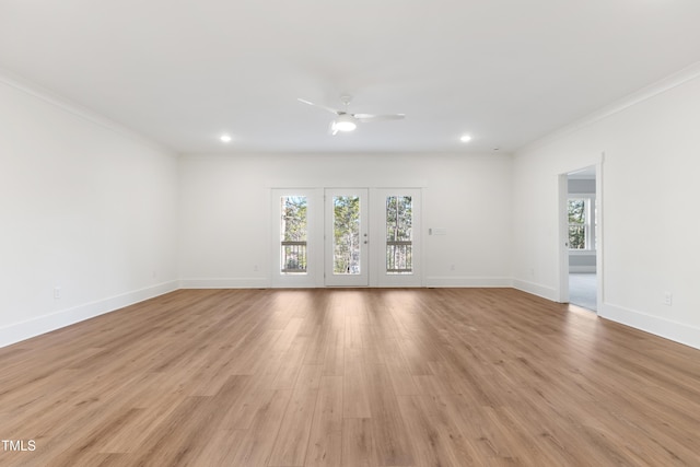 empty room featuring crown molding, light hardwood / wood-style floors, and ceiling fan