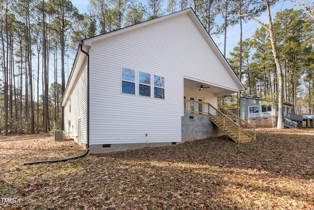 rear view of property featuring covered porch, cooling unit, and ceiling fan