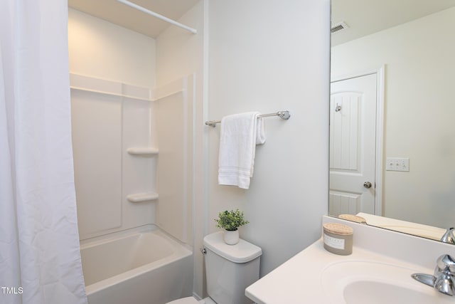 full bathroom with vanity, shower / tub combo, and toilet