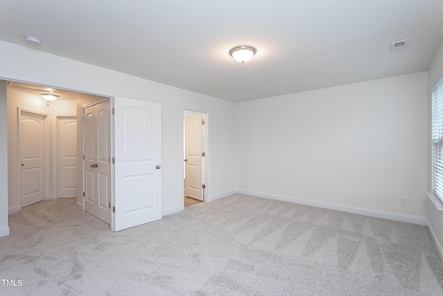 unfurnished bedroom with light colored carpet