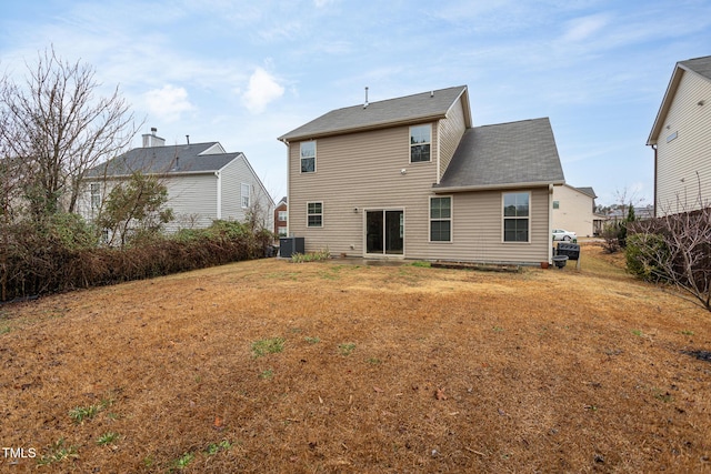 back of property with a lawn and central air condition unit