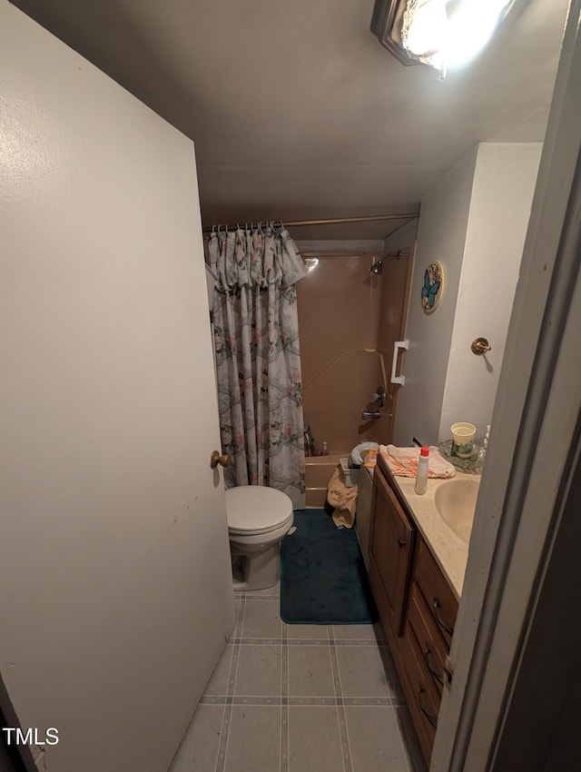 full bathroom with vanity, shower / bath combination with curtain, tile patterned floors, and toilet